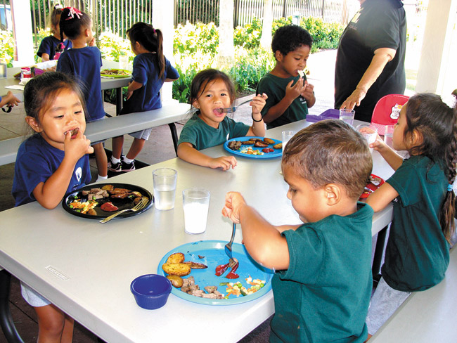 Students at St. Francis Preschool at the St. Francis Intergenerational Center enjoy a healthy lunch of grilled garlic steak, roasted potatoes, mixed vegetables and fresh fruit prepared by Poke Stop. Through St. Francis' partnership with Poke Stop's chef Elmer Guzman, the keiki and adults at the center enjoy fresh, healthy meals every day. Photo courtesy of St. Francis Healthcare System of Hawaii.