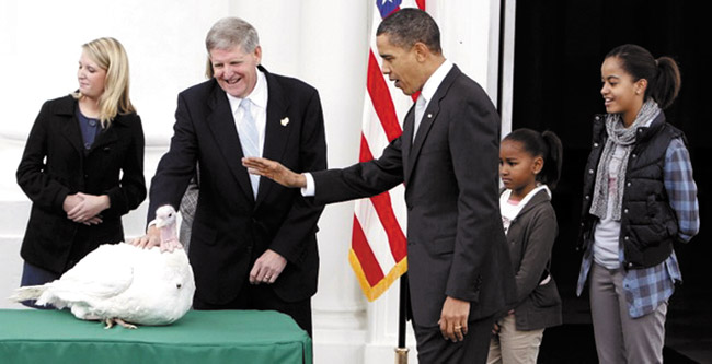 With his daughters watching, President Obama pardons a turkey. AP photo