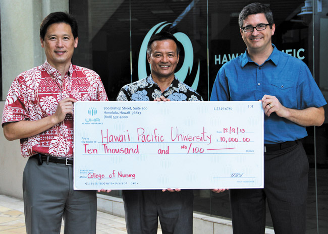University Health Alliance CEO Howard Lee (left) gives Hawaii Pacific University's development director Kevin Takamori and provost Matthew Liao-Troth a ceremonial check for $10,000 to benefit HPU's College of Nursing and Health Sciences, located on the Kaneohe campus. Photo from Chris Aguinaldo.