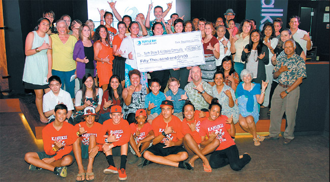 Turtle Bay Foundation awarded $50,000 in grants and scholarships to nonprofits and college-bound students in Windward and North Shore communities Dec. 10 at the resort's Surfer, The Bar. Big winner of the day is represented by the folks in the familiar red shirts (Red Raiders). Photo from the Anthology Group.