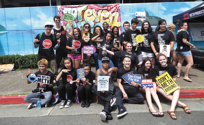 Student organizer Hannah Carnes (back row, with lei) and a few of her schoolmates and performers Feb. 28 at Kalaheo High School's Meth Awareness Day. Photo from Hawaii Meth Project.