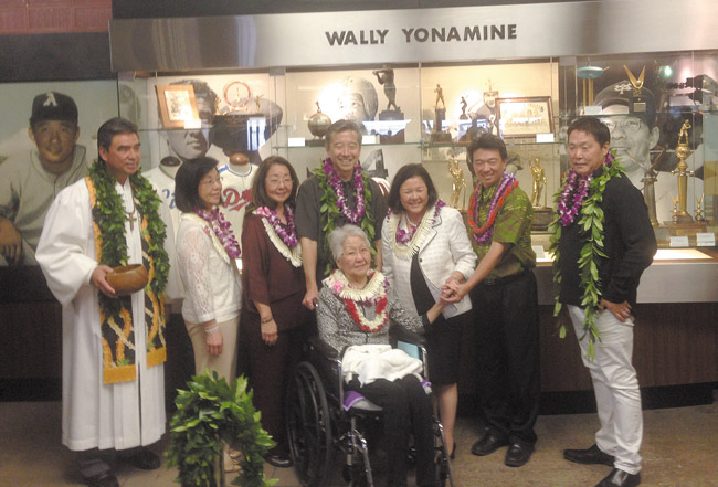 (from left) Kahu Wendell Davis, Amy, Wallis, Paul and Jane Yonamine (seated), Irene Inouye, Lt. Gov. Shan Tsutsui and Kurt Osaki during the April 11 ceremony for the exhibit 'Celebrating our Local Heroes,' which commemorates baseball legend Wally Yonamine and U.S. Sen. Daniel Inouye at Honolulu International Airport. Photo courtesy Paul Yonamine