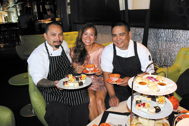 Stage Restaurant and Tea at 1024 present Low Tea in The Lime Lounge. Guests can now enjoy traditional afternoon tea served on low tables in the foyer of Stage Restaurant atº Honolulu Design Center. Pictured here are Michele Henry with pastry chef Cainan Sabey on the left and Stage executive chef Ron de Guzman on the right.