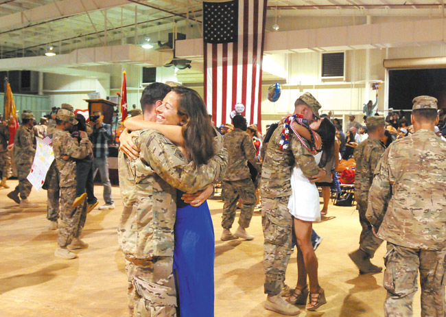 Nearly 200 soldiers from the 65th Engineer Battalion reunite with family and friends at Wheeler Army Airfield after completing a nine-month deployment to Afghanistan. U.S. Army photo by Staff Sgt. Gaelen Lowers, 8th Theater Sustainment Command Public Affairs.