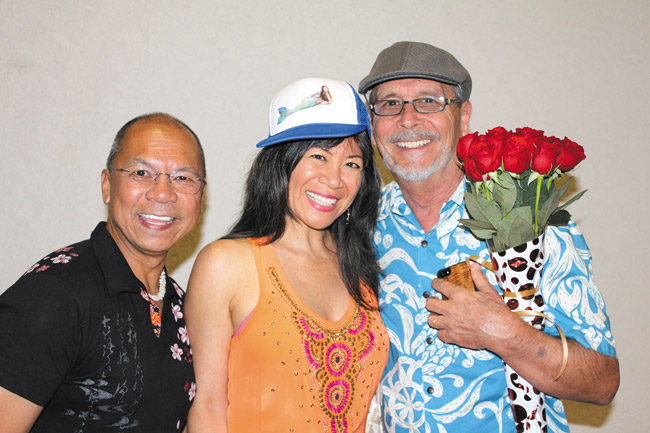 Miss Hawaii Organization producer Ray Abregano with Kanoe and Kim Taylor Reece. On Kanoe's hat is a photo of Tarah as a mermaid taken by Kim.