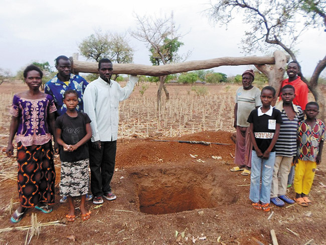 Villagers in Burkina Faso gather to show off their new water well, one of 10 dug this year and funded in 2013 by nine churches, including Windward Church of the Nazarene in Kaneohe. Photo from Dennis Hida.