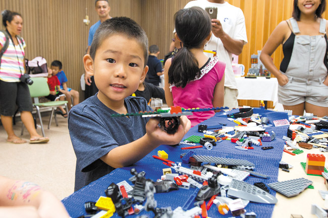 Five-year-old Tristan Takano shows off the airplane he made July 26 during the free Leahi Lego Enthusiasts' hands-on session and display at Wahiawa Library, where adult Lego fans shared their toys and creative skills with the children. Photo by Anthony Consillio, aconsillio@midweek.com.