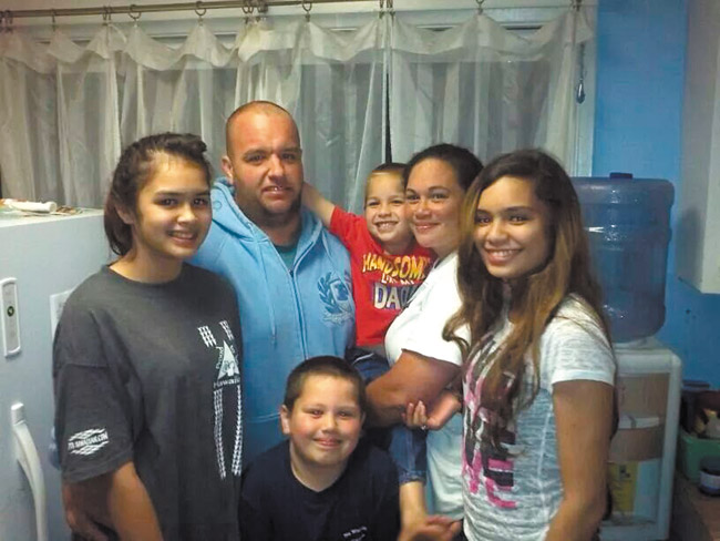 Costa ohana (from left) Celia, Louis, Louis Jr., Melissa, Briana and Elijah (front) were thankful to have lights back on Aug. 10. Their food and water storage helped them weather the storm. PHOTO COURTESY WILLIAM BUCASASAS