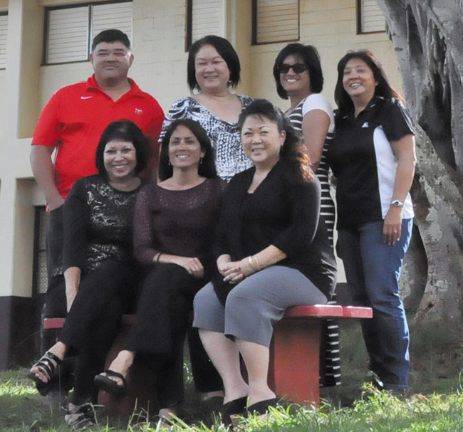 Kauai High Centennial Committee poses under the banyan tree planted by the class of 1936: (front, from left) Darnell Aquino, Penny Vess, Leah Aiwohi, (back) Dino Pabre, Marlene Wong, Carrie Nakaahiki-Young and Laurie Yoshida. PHOTO COURTESY KAUAI HIGH CENTENNIAL COMMITTEE