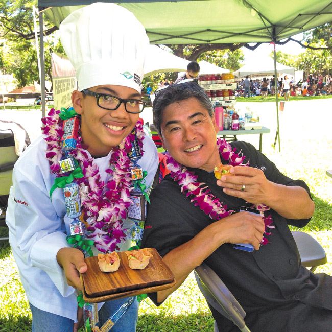 Hunter Gentry shares one of his prize-winning shrimp and vegetable wontons with chef Roy Yamaguchi. Photo from Lela Gentry.