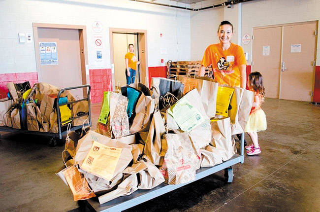 Christina Laney Wycheck pushes a cart of donated food during last year's collection drive. Photo courtesy Christina Laney Wycheck.