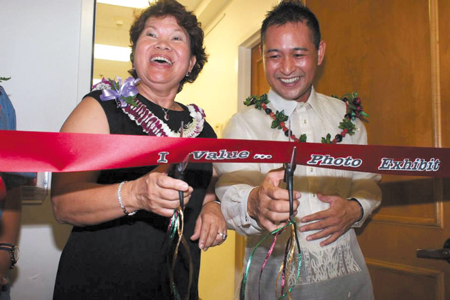 Cutting the ribbon at the 'I Value ...' exhibition opening Oct. 26 were University of the Philippines Alumni Association of Hawaii 2014-2016 president Melody Calisay and FilCom executive director Donnie Juan. The exhibition is on view through Nov. 29. Photo by Julian Llena.