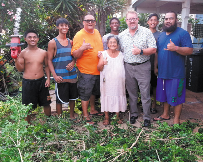 Pictured at the cleanup at Lourdes Torres' home are (from left) Jomar Gapusan, Ryan Cabanilla, Kurt Fevella, Torres, Reggie Knowels, state Rep. Bob McDermott, Christian Corpuz and Campbell JV assistant basketball coach Joe Atinma. Photo from Rep. McDermott's office.