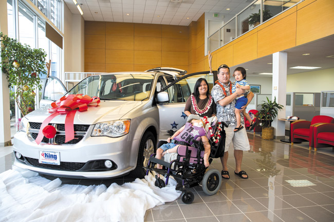 The Okimoto ohana (from left): Kelsie, mom Jennifer and dad Devin holding Kyler with their customized van at King Windward Nissan. The dealership, along with GoldenBoy Mobility and Make-A-Wish Hawaii, teamed up to help the family as Kelsie has a life-threatening condition and is wheelchair-bound. Photo from Make-A-Wish Hawaii.