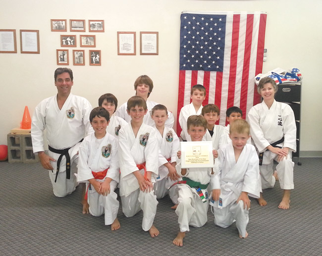 Senseis David and Stacie Knight (back) pose with students at Knight's Isshin-Ryu Karate & Kobudo LLC in Kailua. The couple's school recently was named Kailua Chamber of Commerce 2014 New Business of the Year. With them are (front, from left) Jacob, Zachary, William, Colin, (center) Reilly, Evan, Cainan, Kelii, (back) Gabe and Geroge. Photo from the Knights.