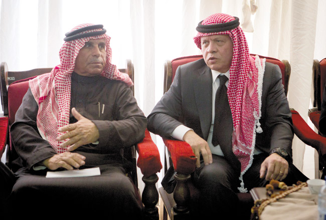 Jordanian King Abdullah II (right) talks with Safi al-Kaseasbeh, father of slain Jordanian pilot Lt. Muath al-Kaseasbeh, after his arrival to offer his condolences at the memorial tent set up for the slain pilot at their home village of Ai near Karak, Jordan, Feb. 5 NASSER NASSER / AP PHOTO