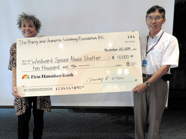 Murray Visser (right), president of Rotary Club of Windward Oahu, presented this $10,000 check to Wind-ward Spouse Abuse Shelter executive director Avis Kalama. The club earned the Weinberg Friends grant through community service in order to give it to a charity of its choice. Photo from Murray Visser.