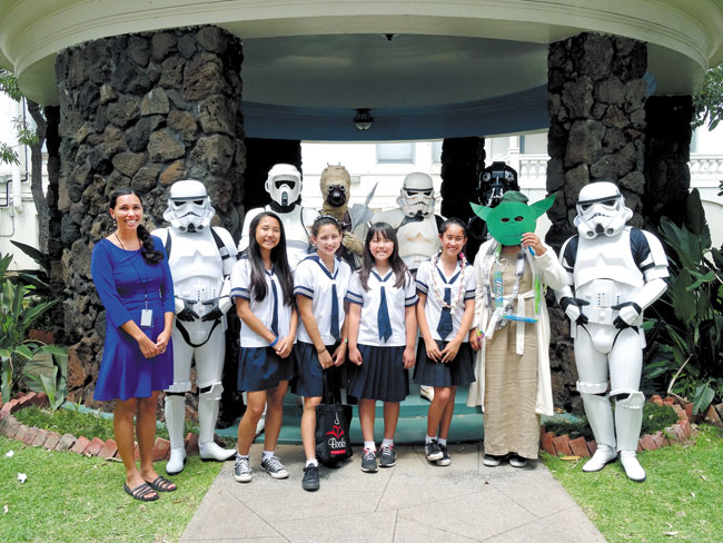 At a Nene Awards gathering in this galaxy last month at Sacred Hearts Academy Lower School were SHA media specialist Lauren Oshiro (front, from left) Stormtrooper, students Rachel Huang, Annika Lindberg, Ayla Hakikawa and Emma Kauhane; Yoda, Stormtrooper, (back) Scouttrooper, Tusken Raider, Stormtrooper and Tie Pilot. (See story at left for explanation.) Photo from Hayley Matson-Mathes.