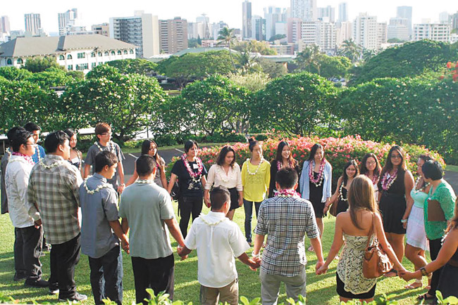PUEO Scholars gather on the lanai of president Jim Scott's home to talk about their college plans with assistant director of PUEO Kylee Mar (far right, in green) PHOTO COURTESY SUZANNE SATO