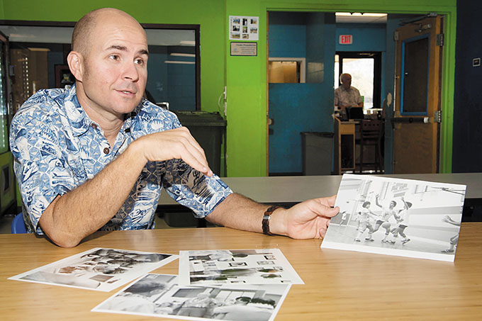Club president Tim Motts checks out photos from the club's early days.