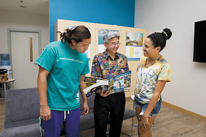 Senior Lucas Wegehaupt, Environmental Science and Biology-Human Health Sciences major, and April Banks, Master's in Diplomacy and Military Studies student, chat with HPU president John Gotanda NATHALIE WALKER PHOTO