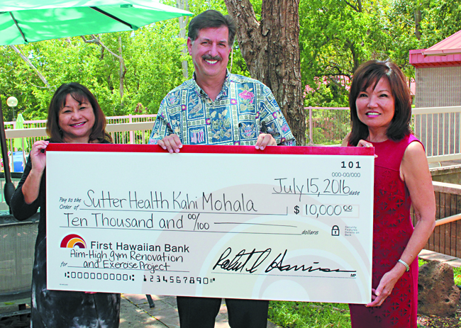 Photo From First Hawaiian Bank FoundationFunds will be used to support Kahi Mohala’s “Aim High” gym renovation and recreational therapy program, serving between 300 and 500 child and adult patients annually. Pictured (from left) are Martha Camacho, vice president and area manager of First Hawaiian Bank, Leonard Licina, CEO of Kahi Mohal, and Sharon Shiroma Brown, president of First Hawaiian Bank Foundation. Photo from First Hawaiian Bank Foundation.