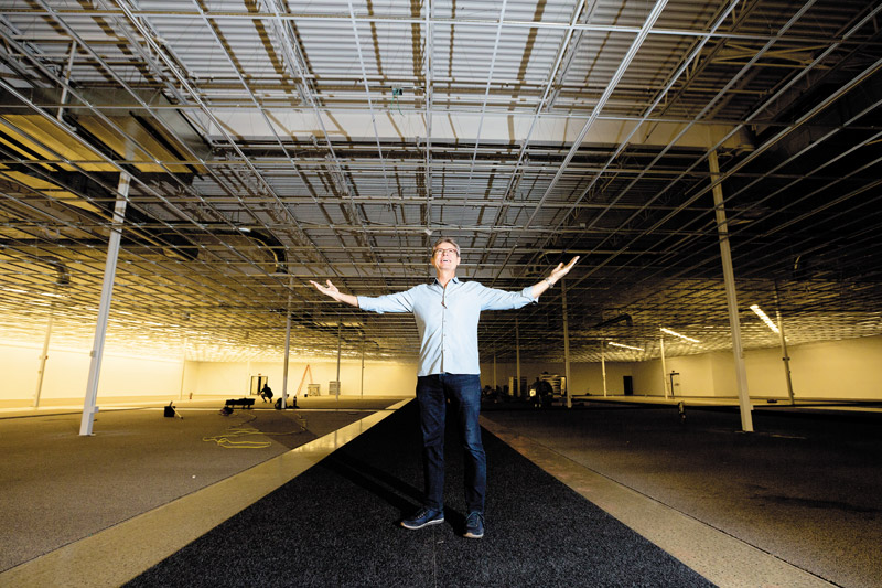 Owner Thomas Sorensen standing in the unfinished showroom at the new INspiration at Kapolei Commons