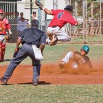 Kalen Iwai beats pitcher Travis Koga to the plate.